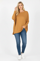 Plus-size oversize poncho sweater in camel with round neck, paired with blue jeans
