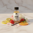 Perfume oil bottle: Gingham Gorgeous by Cathy's New Look, surrounded by lemon/orange slices, strawberry, vanilla pod and flowers