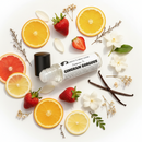 Gingham Gorgeous body oil perfume by Cathy’s New Look; bottle amid citrus slices, strawberries and vanilla pods.