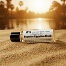 Superior Egyptian Musk fragrance oil bottle by Cathy’s New Look on sandy beach at sunset.