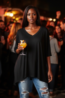 Oversize V-neck poncho top in black with 1/2 sleeves; casual shirts and tops