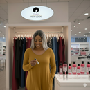 ZENANA PLUS VISCOSE LONG SLEEVE ROUND NECK POCKET DRESS in mustard on a model in a boutique.